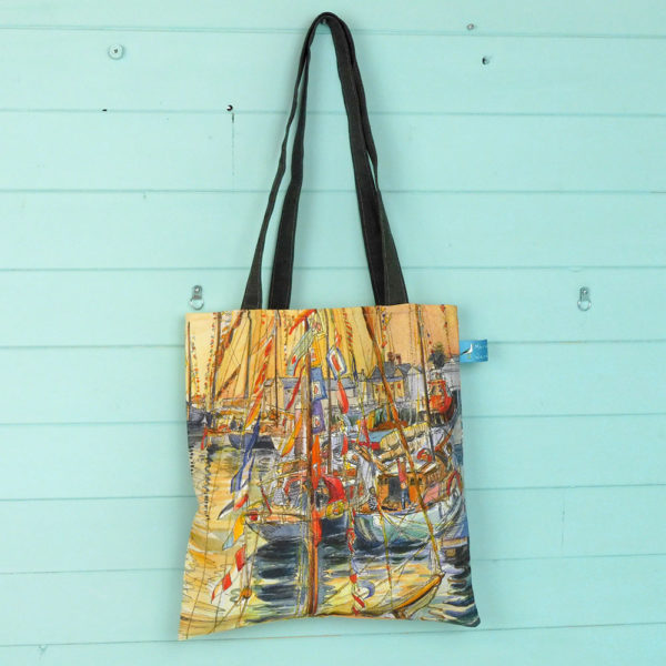 a tote bag printed with old gaffers sailing boats at sunset at Yarmouth on the isle of wight